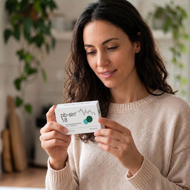 Person examining a PB-SIN 18 package